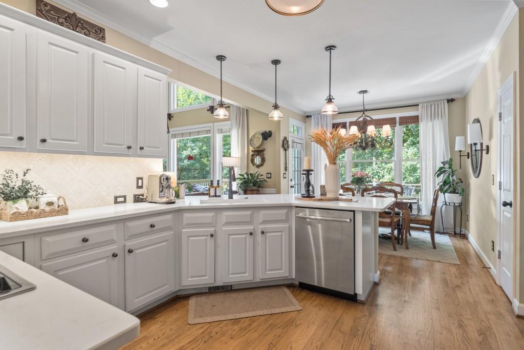 4140 River Bluff Run Way Suwanee, GA 30024 - Photo 8 of 83 a kitchen with sink cabinets and wooden floor