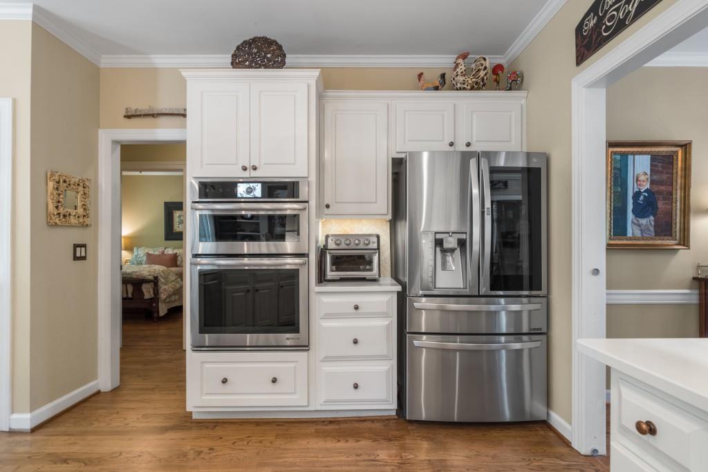 4140 River Bluff Run Way Suwanee, GA 30024 - Photo 10 of 83 a kitchen with stainless steel appliances and white cabinets