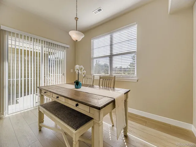 a dining room with a table and chairs