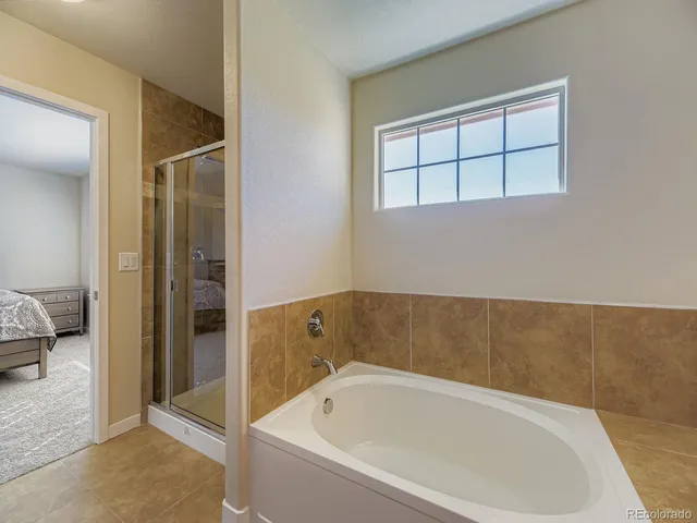 a bathroom with a tub and a shower