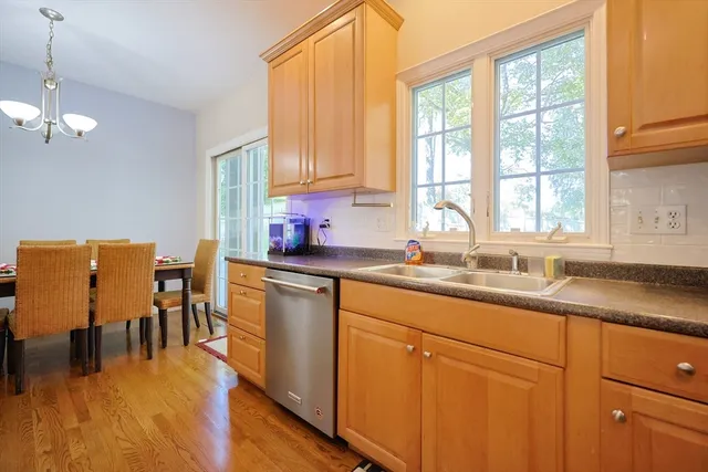 a kitchen with sink a window and chairs