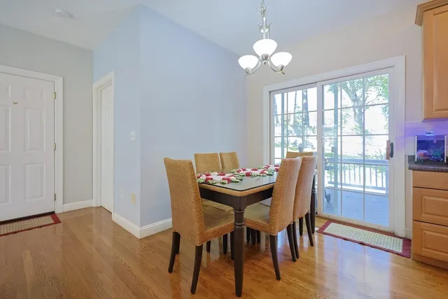 a dining room with furniture wooden floor and a chandelier
