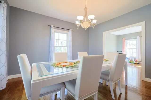 a view of a dining room with furniture wooden floor and chandelier