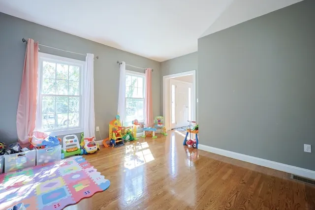 a living room with furniture and floor to ceiling windows