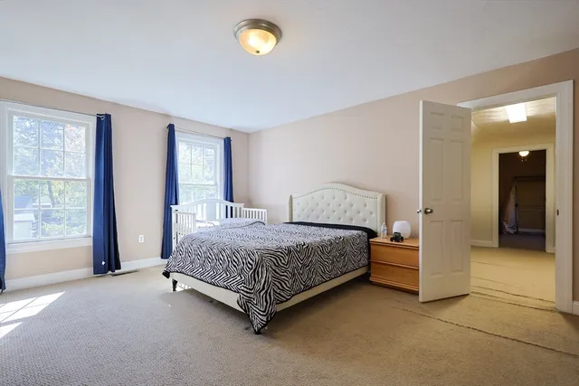 a spacious bedroom with a bed and a cabinets