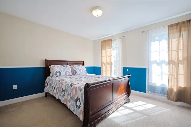 a spacious bedroom with a bed and a window