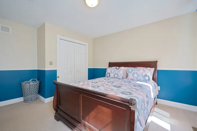 a bedroom with a bed and a lamp with window