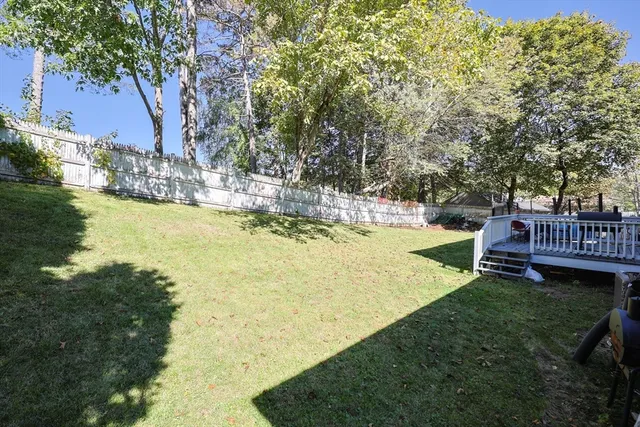 a view of a garden with wooden fence