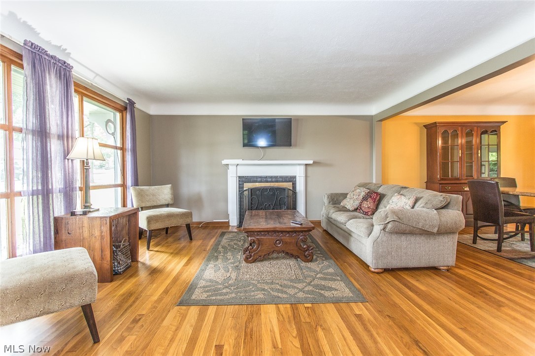 1092 Ford Road Lyndhurst, OH 44124 - Photo 3 of 22 The open living room has large windows and a gas fireplace.