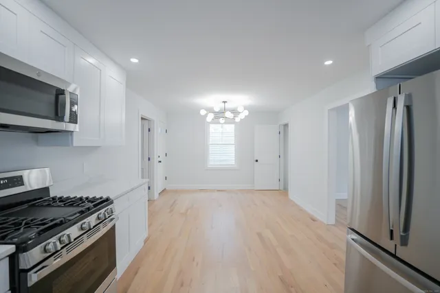 a kitchen with stainless steel appliances a stove a microwave and a refrigerator
