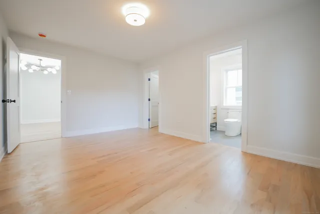 a view of a room with wooden floor and a sink