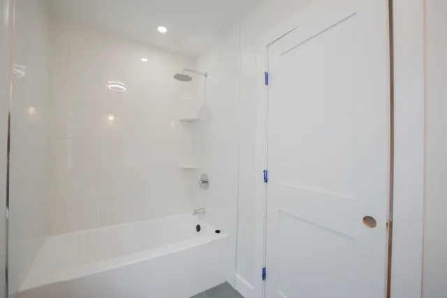 a bathroom with a bathtub and a shower
