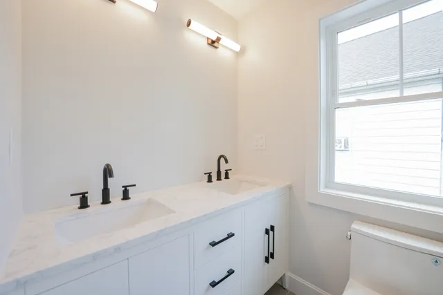 a bathroom with a sink and a window