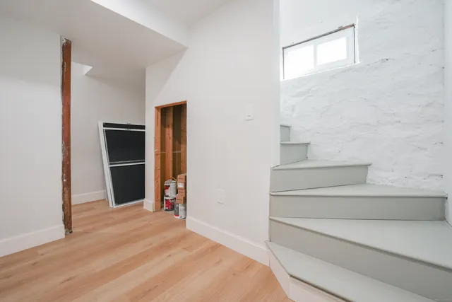 a view of empty room with wooden floor and closet