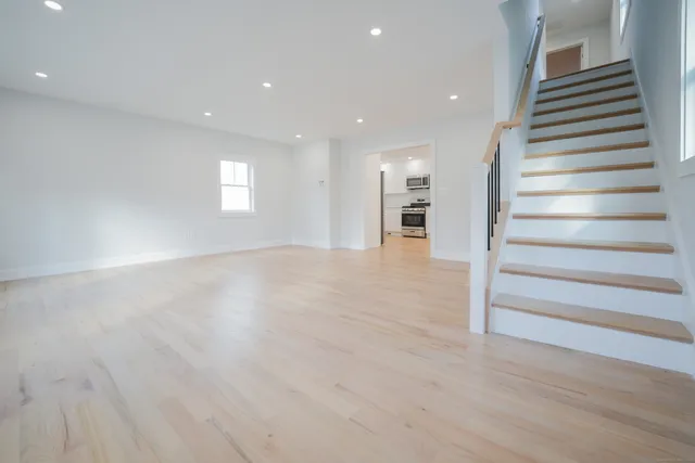 a view of a room with wooden floor and entryway