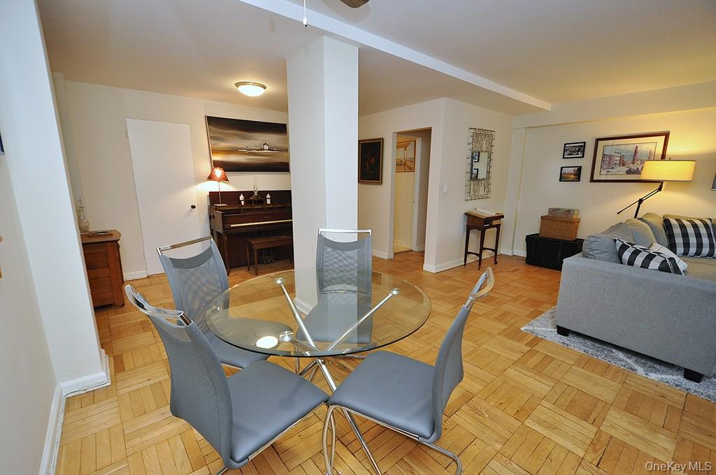 235 Garth Road, Unit A5B Scarsdale, NY 10583 - Photo 15 of 47 a living room with furniture a flat screen tv and kitchen view