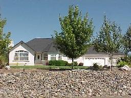 13087 Spring Lake Street Redding, CA 96003 - Photo 1 of 1 a front view of a house with a garden