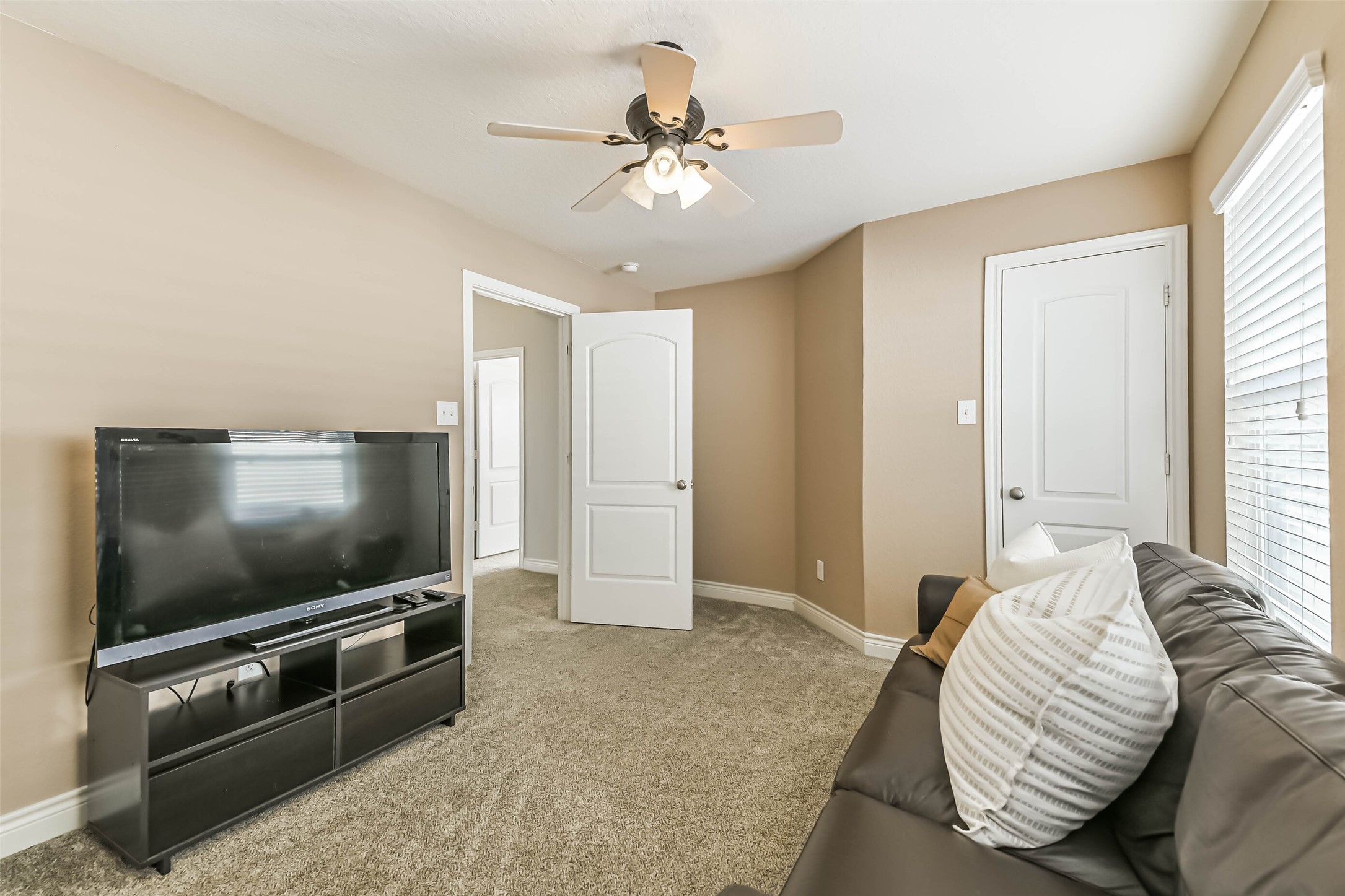 19022 Greenleaf Ridge Court Cypress, TX 77429 - Photo 43 of 47 a living room with furniture and a flat screen tv