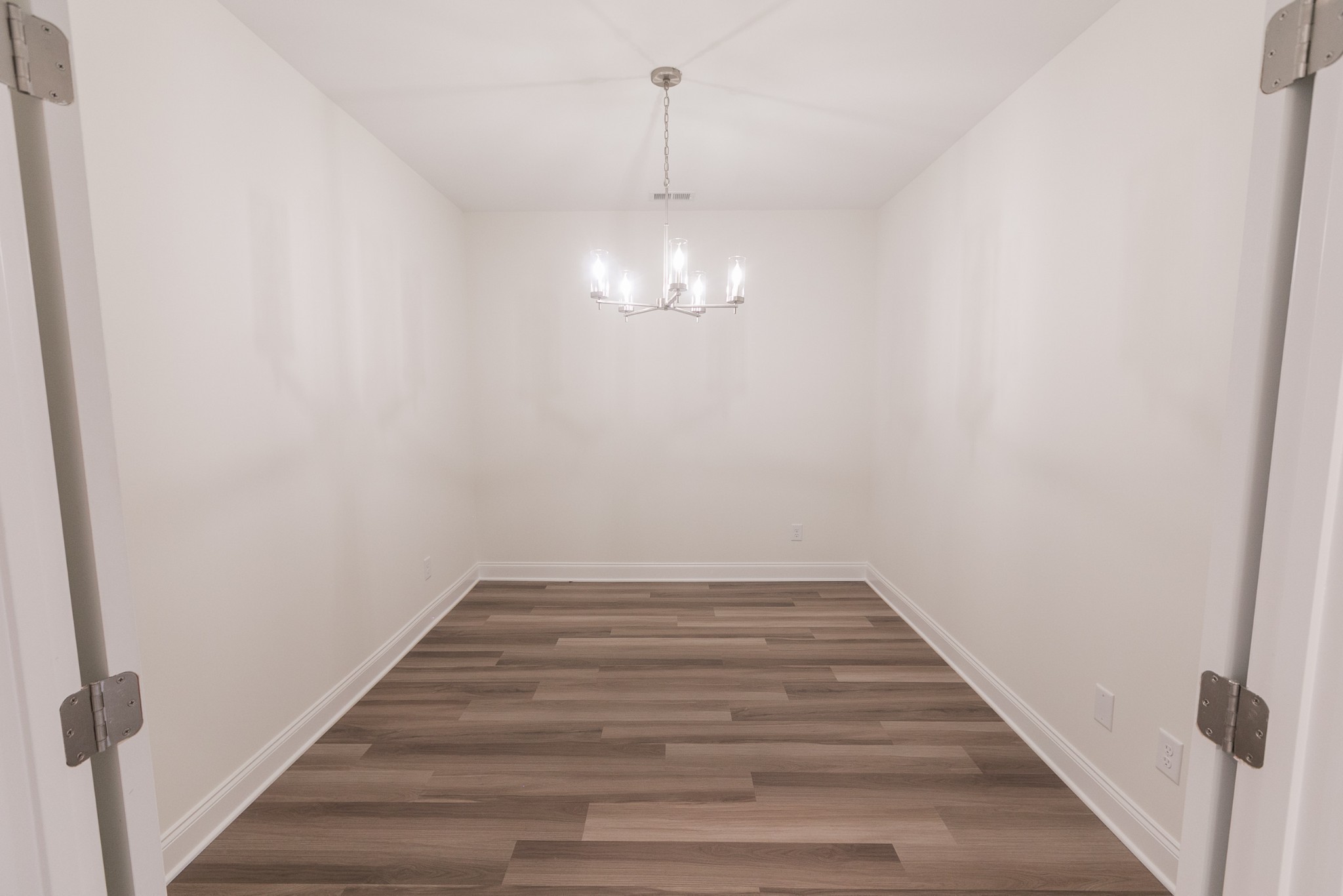 422 West Foxrun Springfield, TN 37172 - Photo 15 of 18 a view of a hallway with wooden floor and a chandelier