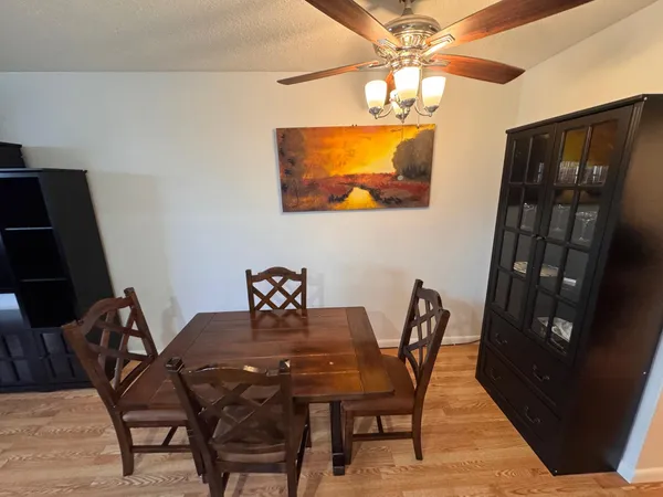 a kitchen with a table chairs and a refrigerator