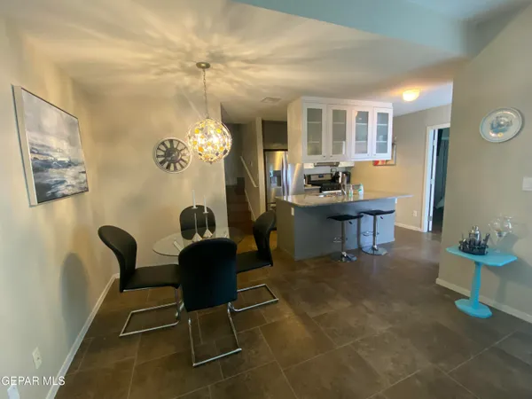 a view of a dining room with furniture and chandelier