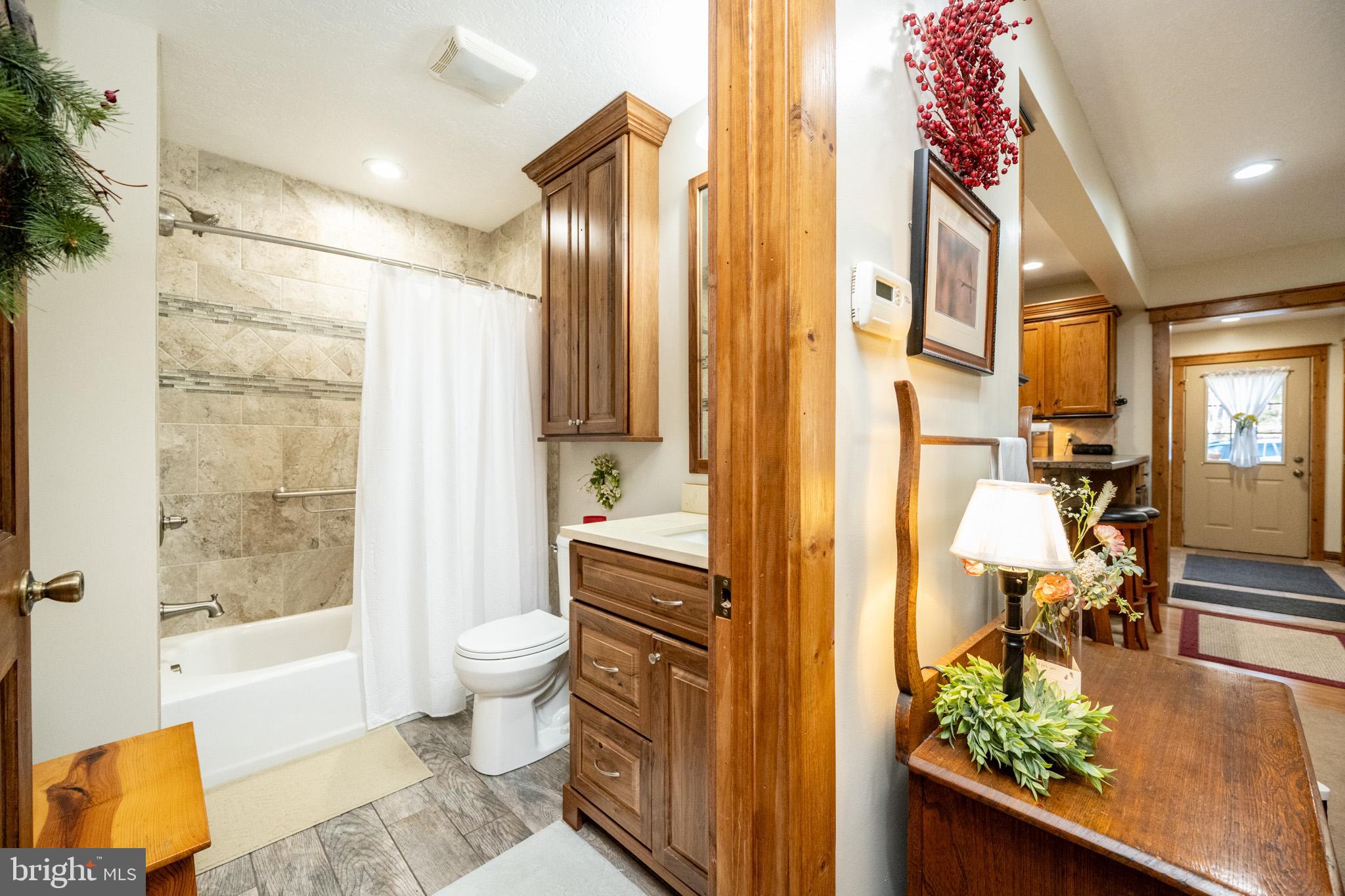 328 Stool Rock Road Oakland, MD 21550 - Photo 11 of 133 a bathroom with a granite countertop sink a toilet and shower