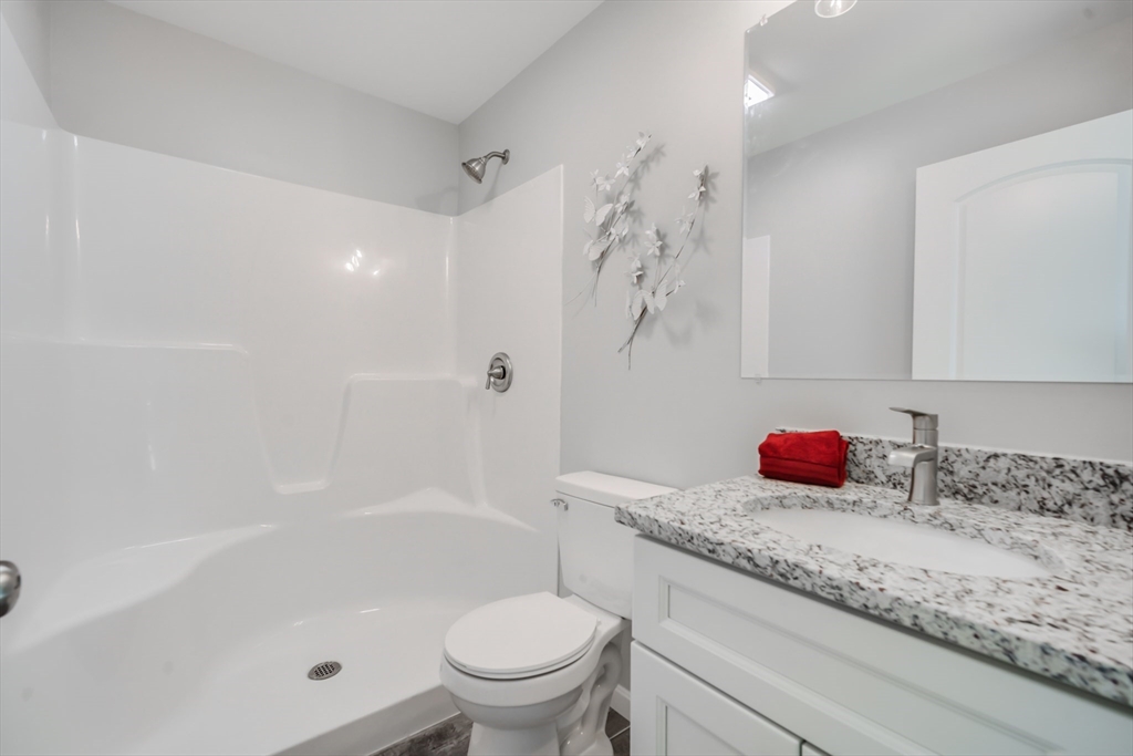 27 Jennings Street Springfield, MA 01119 - Photo 13 of 32 a bathroom with a granite countertop sink a toilet and shower