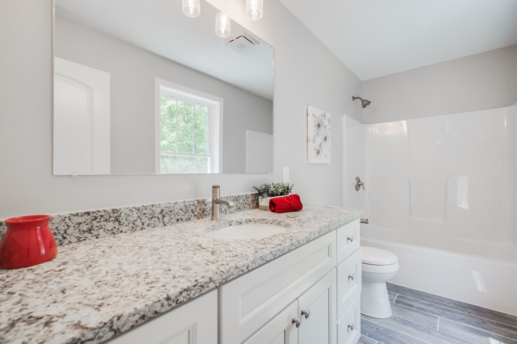 27 Jennings Street Springfield, MA 01119 - Photo 17 of 32 a bathroom with a granite countertop sink a toilet and shower