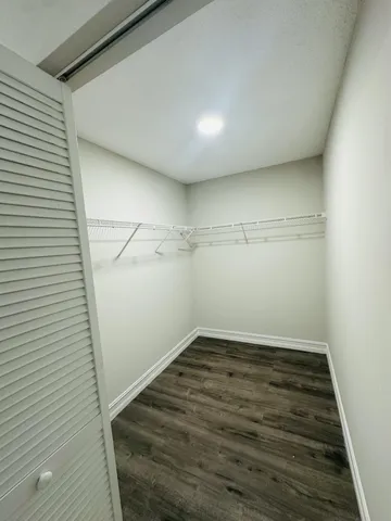 a view of a room with wooden floor