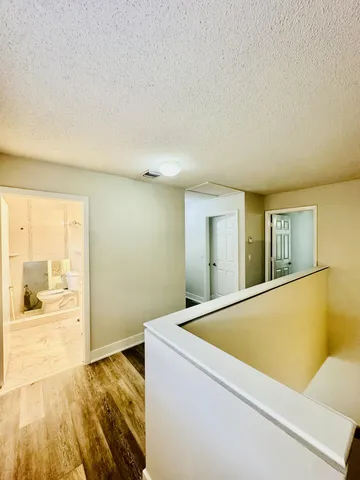 a view of an empty room and wooden floor
