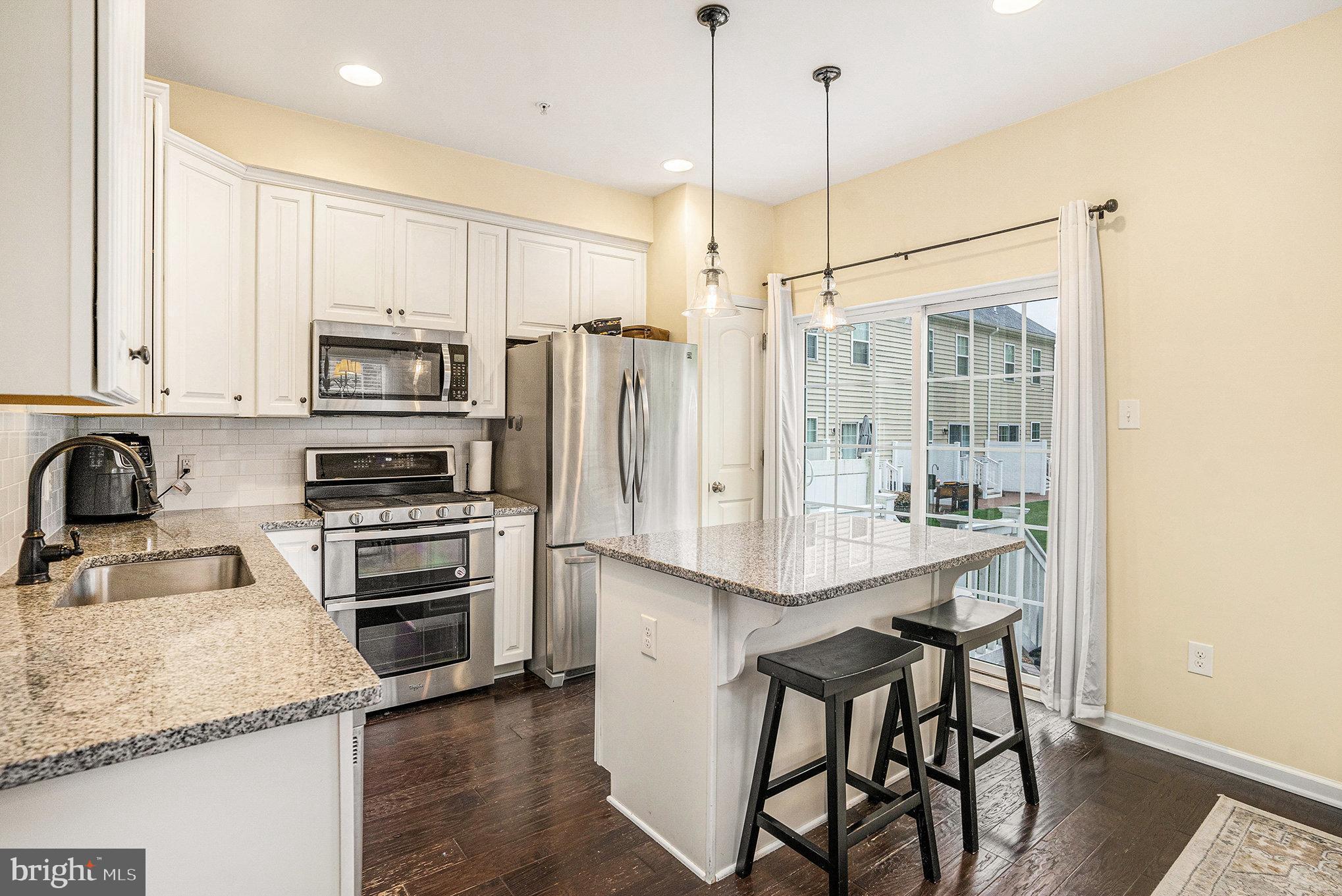 3611 Jacob Stout Road, Unit 8 Doylestown, PA 18902 - Photo 11 of 39 a kitchen with stainless steel appliances granite countertop a sink refrigerator and microwave