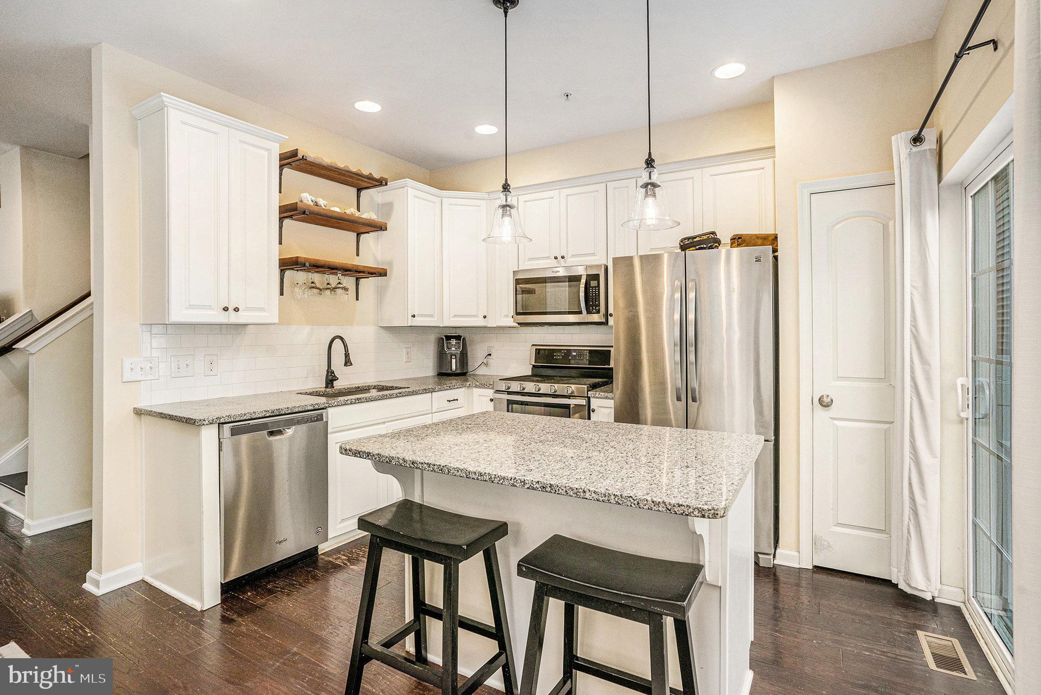 3611 Jacob Stout Road, Unit 8 Doylestown, PA 18902 - Photo 12 of 39 a kitchen with stainless steel appliances granite countertop a refrigerator a sink dishwasher a stove and white cabinets with wooden floor