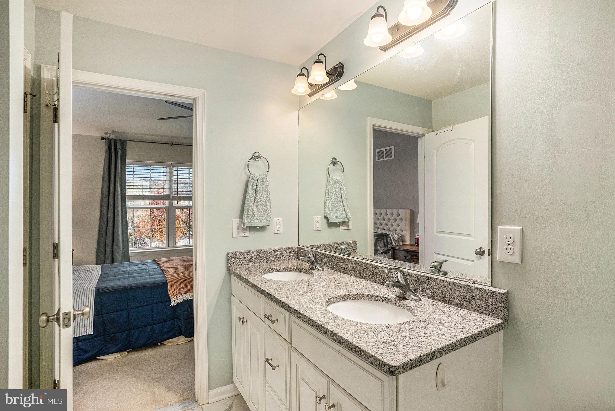 3611 Jacob Stout Road, Unit 8 Doylestown, PA 18902 - Photo 20 of 39 a bathroom with a granite countertop sink and a mirror