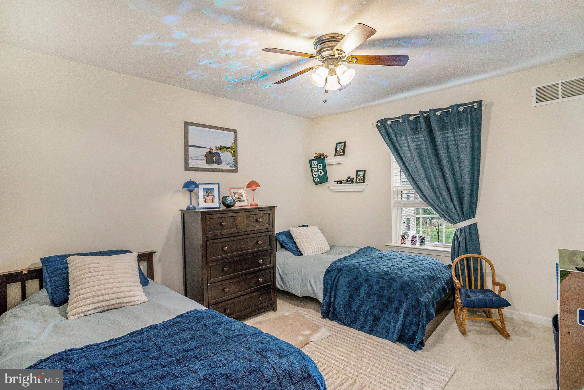 3611 Jacob Stout Road, Unit 8 Doylestown, PA 18902 - Photo 23 of 39 a bedroom with a bed a window and a chandelier