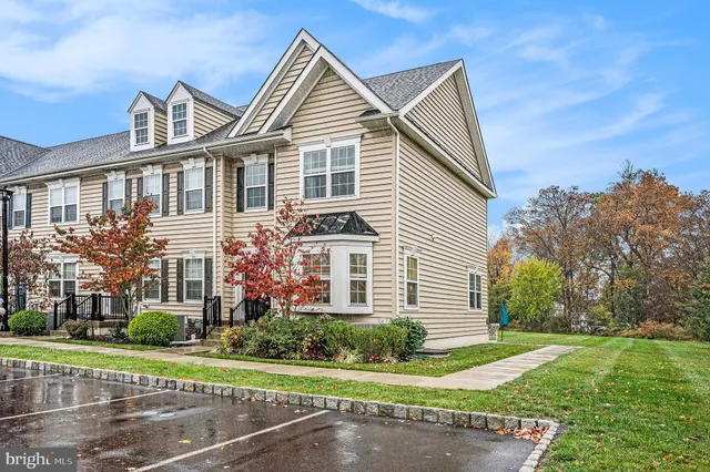 a kitchen with stainless steel appliances granite countertop a refrigerator a sink dishwasher a stove and white cabinets with wooden floor