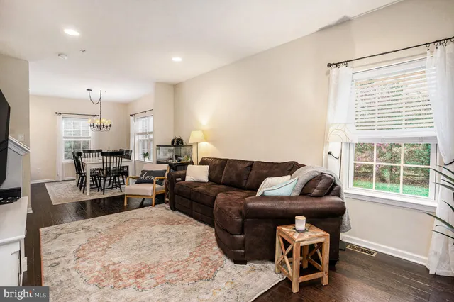 a bathroom with a granite countertop sink a toilet and a mirror