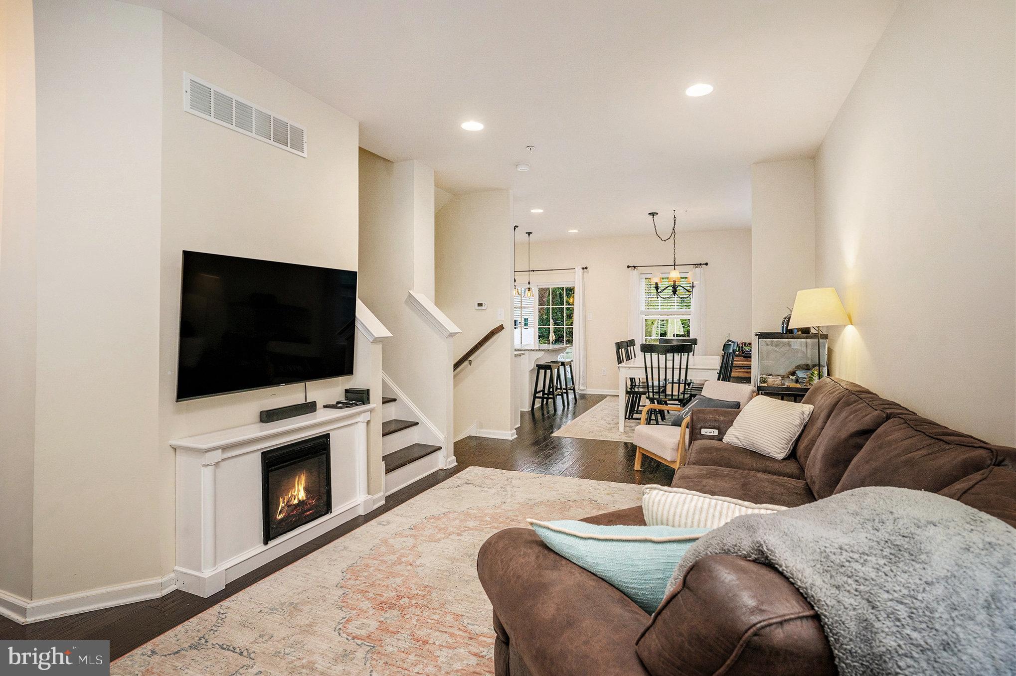 3611 Jacob Stout Road, Unit 8 Doylestown, PA 18902 - Photo 6 of 39 a living room with furniture a flat screen tv and a fireplace