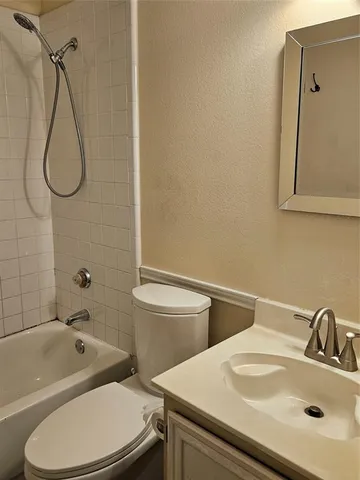 a bathroom with a sink a toilet and a bathtub