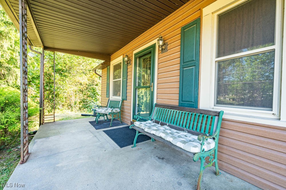 103 Valley Road Damascus, OH 44619 - Photo 22 of 27 View of patio featuring a porch