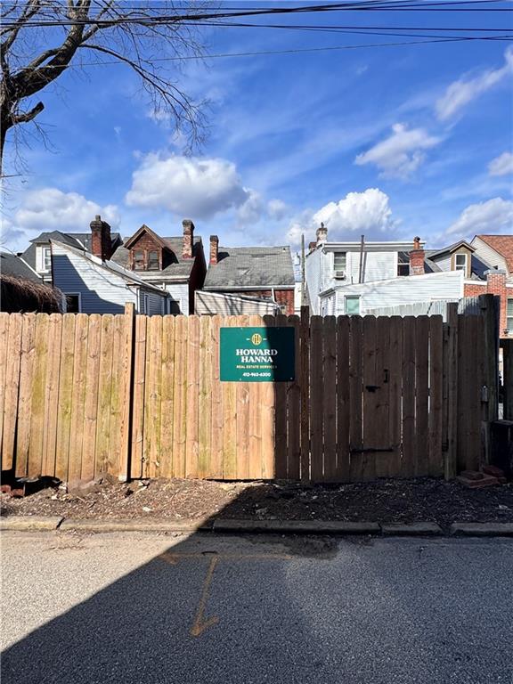 a view of a house with wooden fence
