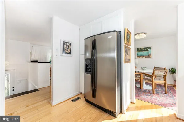 a kitchen with stainless steel appliances granite countertop a refrigerator a stove and a sink