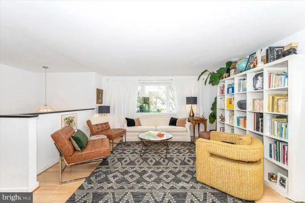 a living room with furniture fireplace and a large window