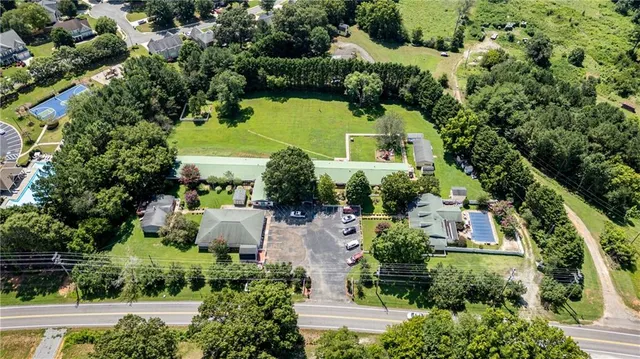 an aerial view of house with yard swimming pool and outdoor seating