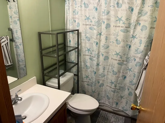 a white toilet sitting next to a bathroom sink