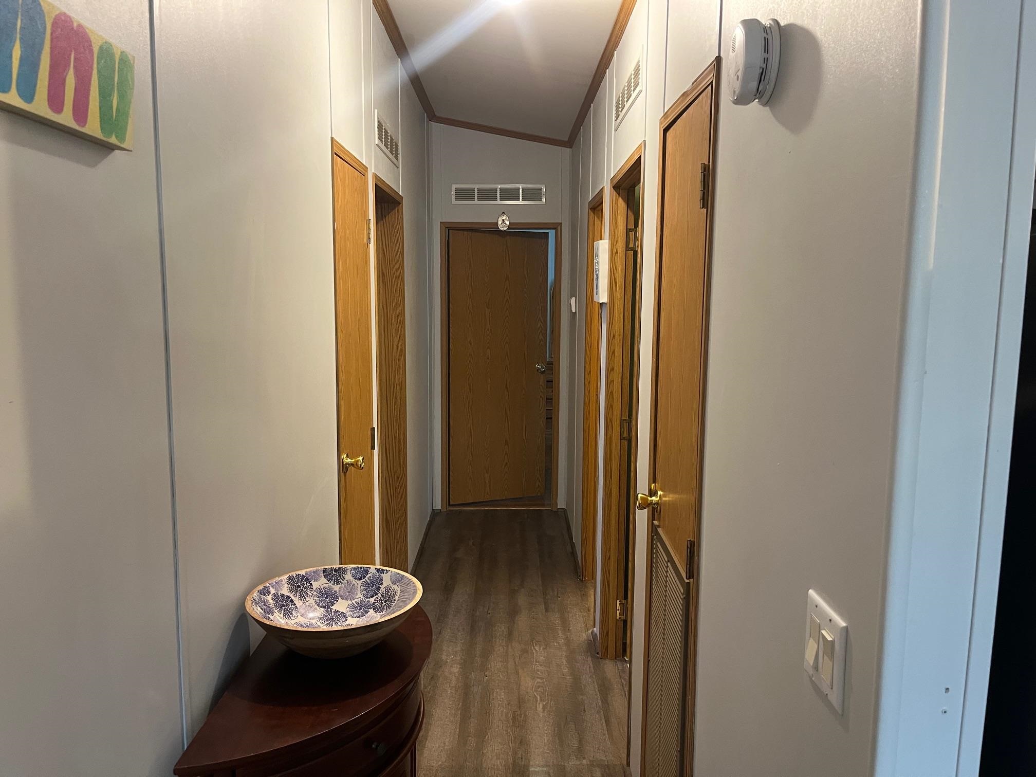 1402 South Rte 9 Cape May Court House, NJ 08210 - Photo 7 of 18 a view of a hallway with wooden floor and chair