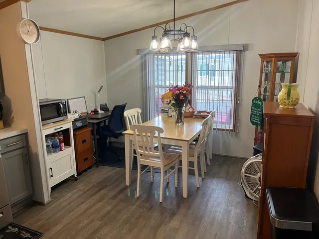 a view of a dining room with furniture and wooden floor