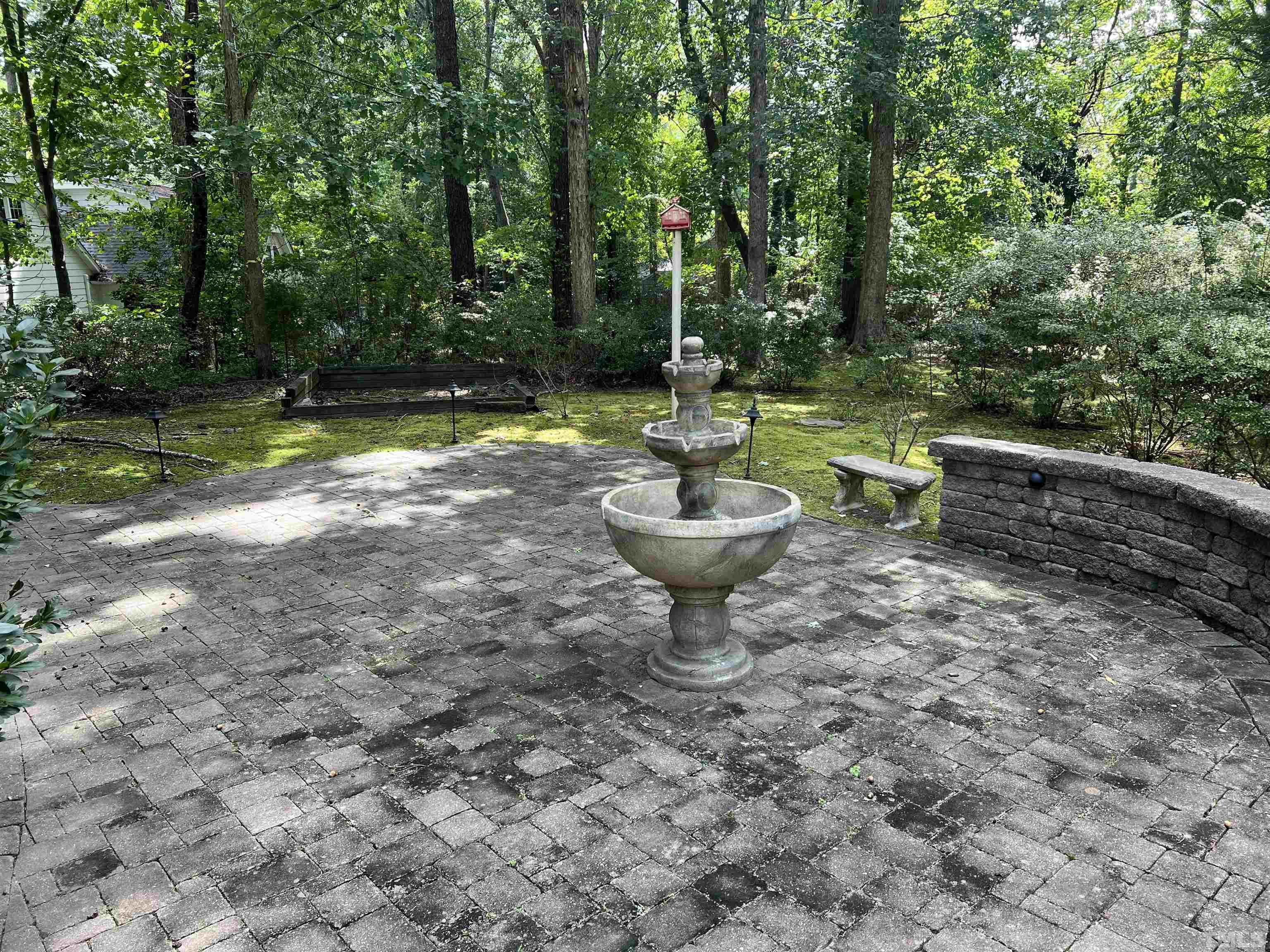 8000 Falling Leaf Court Raleigh, NC 27615 - Photo 9 of 31 a view of a backyard with swimming pool and trees in the background