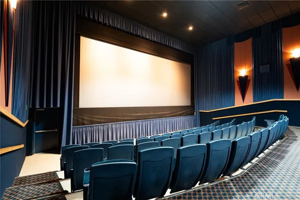 a view of a projector room with furniture and screen