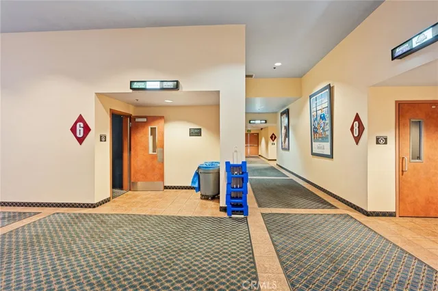 a view of hallway with wooden floor and living room
