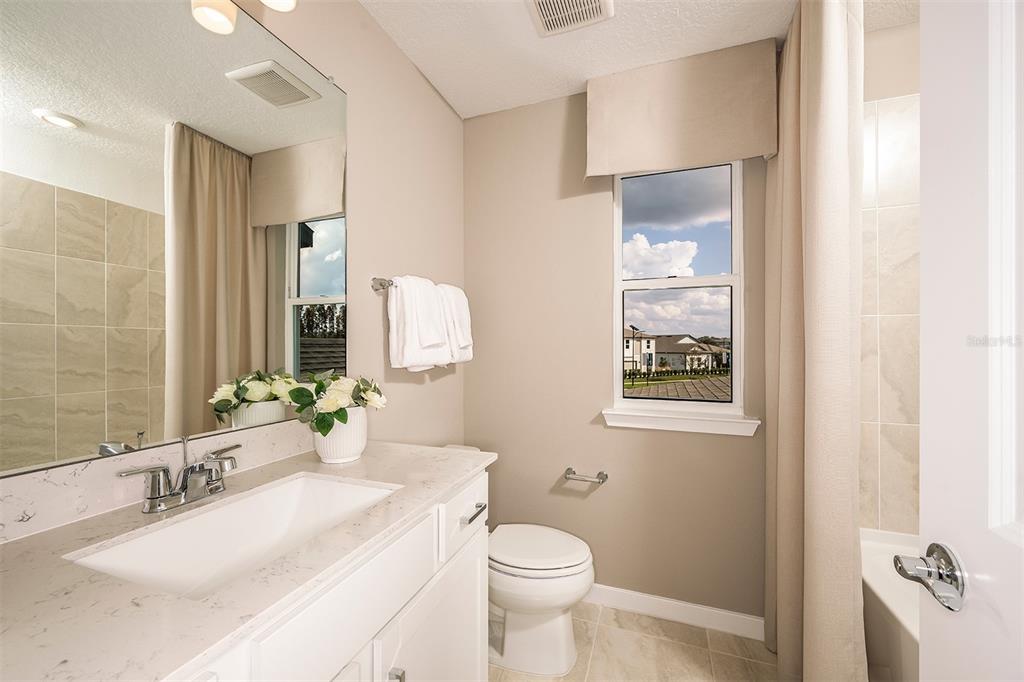 6263 Broad Fld Avenue Apollo Beach, FL 33572 - Photo 16 of 24 a bathroom with a granite countertop sink mirror vanity and toilet